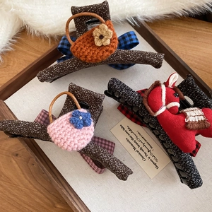 Three-piece set featuring knitted mini bags and rocking horse hair claws with pearls