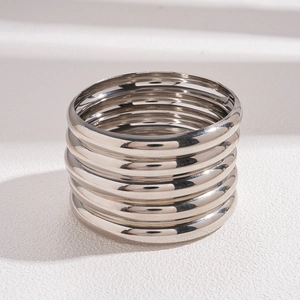 Macro shot of 7-piece polished silver metal bangles showcasing glossy finish and texture