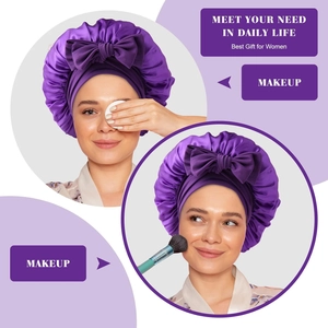 Close-up of purple satin sleep bonnet with bow for makeup and hair protection