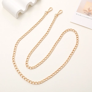 Close-up of flat link gold metal chain strap with swivel lobster clasps for DIY bags
