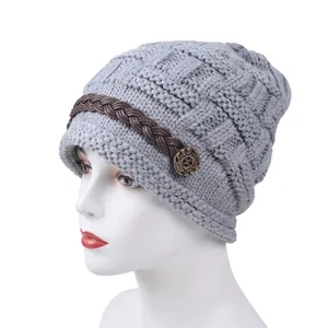 Fashionable light grey knitted beanie with brown braided strap and vintage metal button