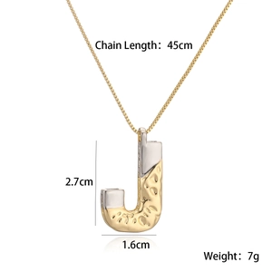 Detail of mixed-metal letter J pendant with hammered texture and 45cm gold chain