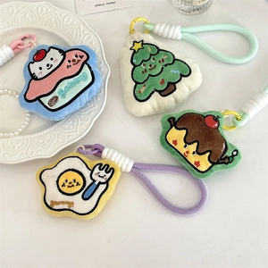 Group of plush cartoon keychains featuring a Christmas tree, cat cake, egg, and pudding dolls