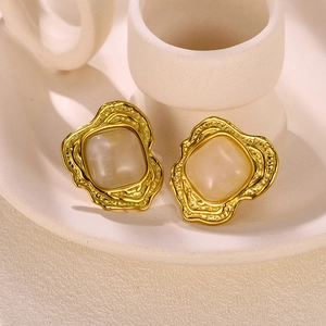 Vintage style gold sunflower earrings with translucent square stone on ceramic tray