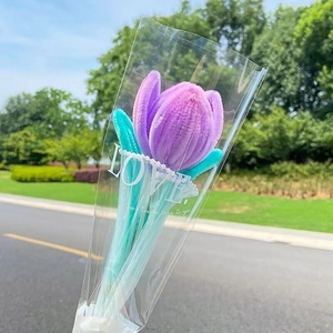 Handmade purple tulip flower bouquet made of pipe cleaners in transparent love packaging