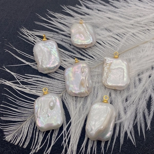 Baroque natural freshwater pearl pendants in rectangular shapes with gold connector loops