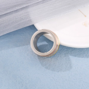 Classic three-tone interlocking rolling ring in silver gold and rose gold finishes