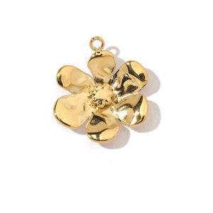 Macro detail of a golden flower pendant crafted from polished stainless steel for jewelry
