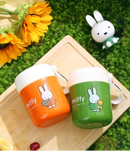 Detail of Miffy insulated soup cups with handle on a picnic tray with flowers