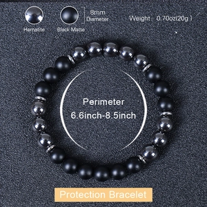 Protection bracelet with 8mm black matte stones and polished hematite beads on a dark base