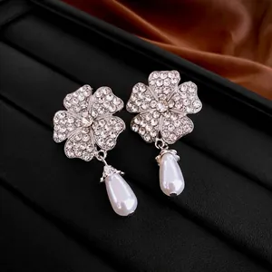 Elegant silver flower drop earrings with crystal pavé and white teardrop pearl accents