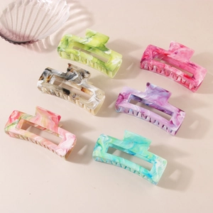 Set of six colorful marble pattern rectangular hair claws in various vibrant shades