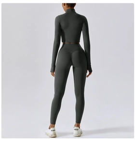 Rear view of seamless charcoal yoga set featuring cropped long sleeve top and high waist leggings