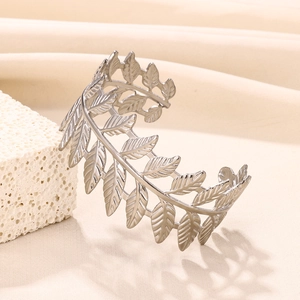 Detail of silver leaf cuff bracelet showing intricate vein texture on stainless steel