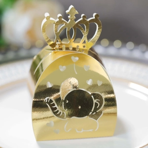 Detail of laser-cut crown gift box in metallic gold with cute elephant pattern