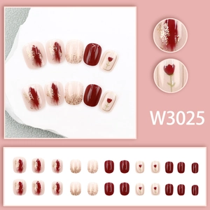 Short round red and beige press-on nails with tulip art and gold glitter detail