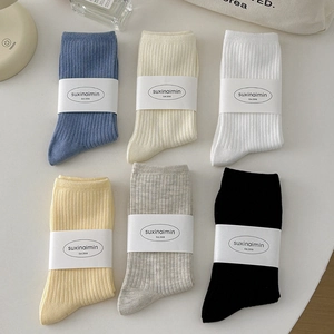 Set of six ribbed cotton mid-calf socks in assorted neutral colors for a cozy minimalist look