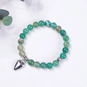 Detail of green agate beaded bracelet featuring a silver heart charm and vintage beads