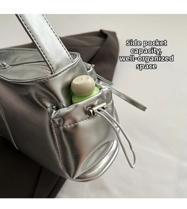 Detail of silver PU bag side pocket with adjustable drawstring for small accessories