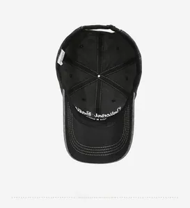 Detail view showing black cotton baseball cap interior with embroidery and metal buckle