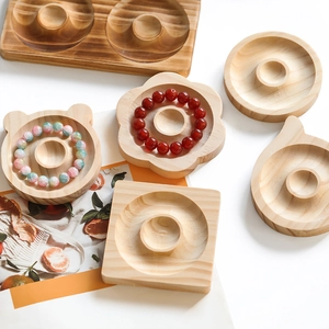 Detailed view of various shaped wooden jewelry display trays with bead storage slots
