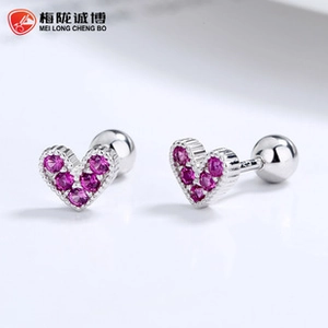 Macro detail of 925 sterling silver heart stud earrings with pink zirconia and screw back