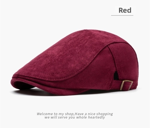 Detail view of burgundy newsboy cap featuring side metal adjustment buckle and suede texture