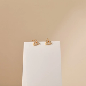 Close-up of geometric hollow triangle stud earrings with sparkling micro-pave zircons