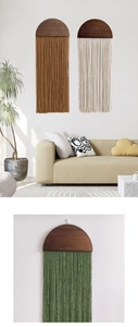 Detail of handcrafted bohemian wall hanging with wooden semicircle and woven tassels