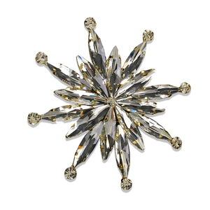 Macro shot of luxury silver snowflake brooch with sparkling faceted crystals and metal pins