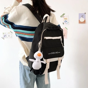 Detail of Korean style campus backpack in black and white with a cute duck keychain