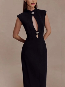 Detail view of the black sleeveless dress with cutout chest design and metal buttons
