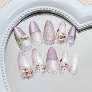 Purple cat eye almond press-on nails with 3D pearl bow and floral designs