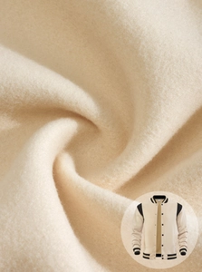Macro shot of thick beige fleece fabric texture for American style baseball jacket