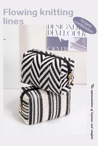 Detail of woven cosmetic bags featuring black and white chevron and stripe knit patterns