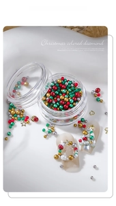 Detail of Christmas nail art charms with colorful beads and metal shapes in a jar