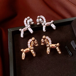 Macro shot of 18k gold plated balloon dog stud earrings with white zircon paving