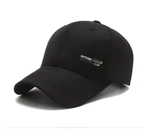 Detail of black cotton baseball cap showing twill texture and metal sport emblem