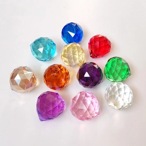 Macro shot of assorted colorful faceted crystal glass beads scattered on white background