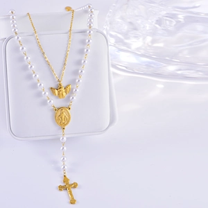 Close-up of layered cross and virgin mary pendants with pearls on a jewelry display