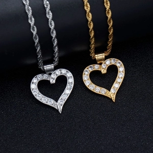 Gold and silver 316L stainless steel heart necklaces with zircon inlay on black background