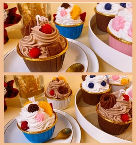Detail of cupcake scented candles with realistic berry toppings and cream textures