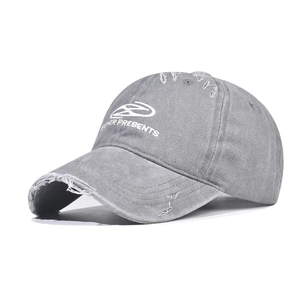 Close-up of vintage washed cotton baseball cap with white 3D embroidery and distressed detail