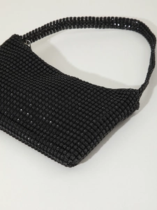 Macro detail of high-density black rhinestones on a mini evening shoulder bag