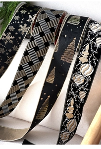 Detailed view of velvet Christmas ribbons with gold and silver snowflake patterns
