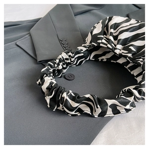 Macro shot of stylish zebra pattern cloud bag with soft pleated PU leather texture