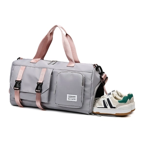 Large gray travel bag with pink straps, featuring a built-in separate shoe compartment