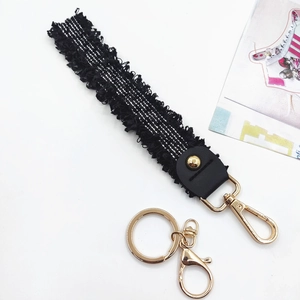 Elegant black and white striped woven lanyard with gold alloy clips and leather accents