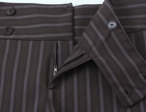 Detailed macro view of striped brown shorts featuring double button waist and zipper closure