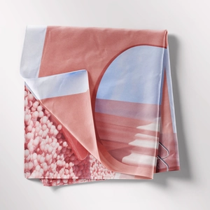Close-up of bohemian tapestry fabric showing soft texture and geometric salmon blue print